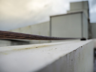 Close-up bare copper and cable saddle of lightning protection on roof top