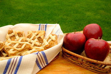 Apple pie and red apples on the table