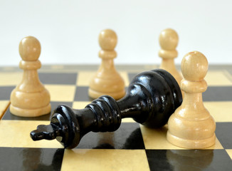 The white pawn defeated black king on chess board