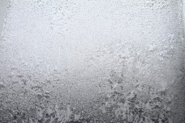 White window glass covered hoarfrost ice pattern texture. Cold nature winter background