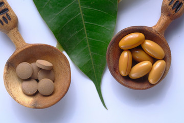 herbal pill and capsule with leaf, top view 