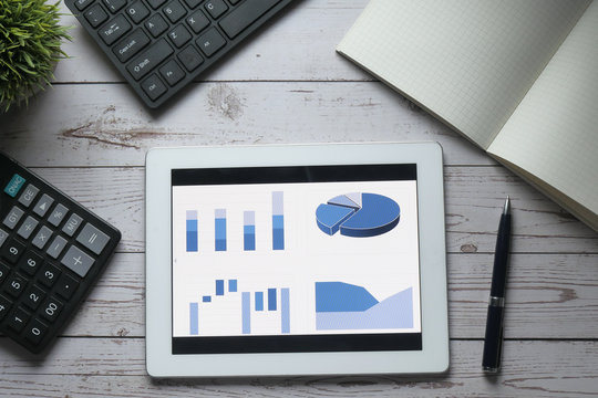 top view of financial chart display on digital tablet on office table 