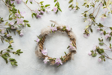 Spring wreath with flowers on light. Creative flat lay. Top view. Decor handmade.