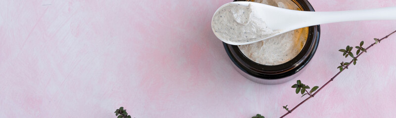 Hygiene bath product. Body, face scrub on pink background. Wellness therapy regeneration