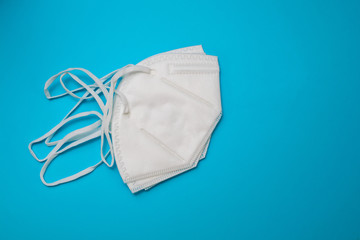 white protective masks on blue paper background.