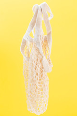 empty string bag on yellow background