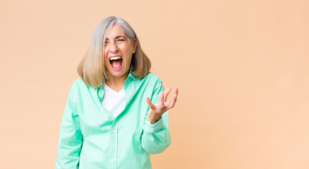middle age cool woman looking angry, annoyed and frustrated screaming wtf or what’s wrong with you