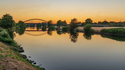 Fototapeta premium A Bridge over the River Ruhr in the evening light, seen in Duisburg, North Rhine-Westfalia, Germany