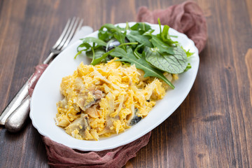 cod fish with mashed eggs on the dish on ceramic background
