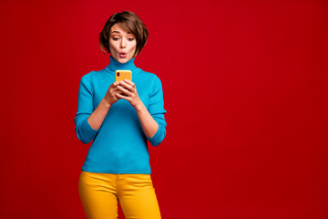 Portrait of crazy funky girl use smartphone read impressed unbelievable social network information look scream wow omg wear stylish outfit isolated over vivid color background
