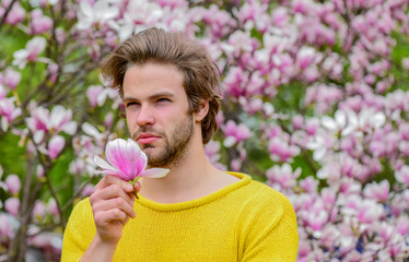 Modern hipster enjoy blossom. Springtime concept. Guy relax in flowers park. Botanical garden. Man flowers background. Freshness and awakening. Spring inspiration. Joy of spring. Spring beauty