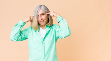 middle age cool woman with a serious and concentrated look, brainstorming and thinking about a challenging problem