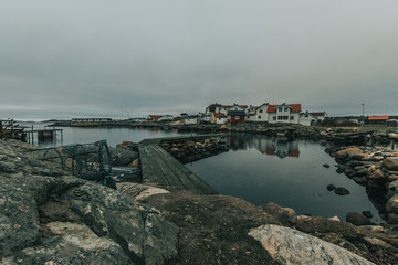 Vr&aring;ng&ouml;, Southern Gothenburg Archipelago / Sweden -  A view of sea shore, a rocky landscape of Vr&aring;ng&ouml; island and its scandinavian wooden houses in Sweden during a cloudy day.