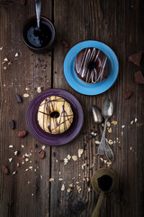 Coloured donuts with chocolate, jam and coffee