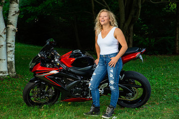 Obraz na płótnie Canvas Young woman and motocycle