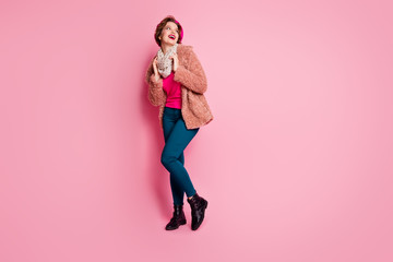 Full body photo of cute sweet cheerful pretty french girl look copy space enjoy free time trip touch scarf wear bright jumper jeans denim isolated over pink color background © deagreez