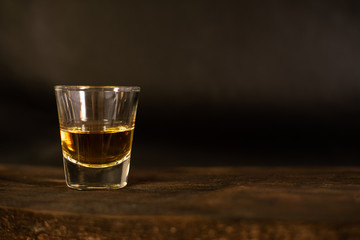Amber whisky on dark background.