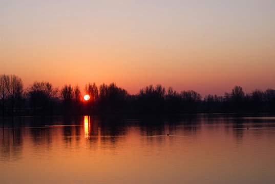 Sunrise above a lake in Arnhem called: Rijkerswoerdse plassen in the Netherlands