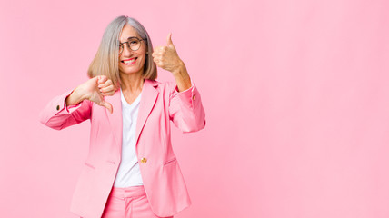 middle age cool woman feeling confused, clueless and unsure, weighting the good and bad in...