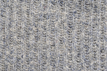 Close-up of a fragment of knitted woolen clothes. Space for lettering or design.