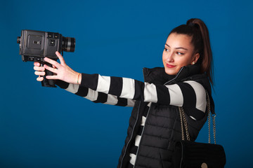 Young, beautiful and elegant girl on studio plain background