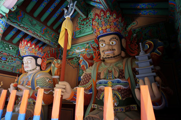 “Heavenly guardians” at the gate. Vaisravana with miniature stupa, Virupaksa. Cheonwangmun (“Guardian Kings Gate”), Beomeosa Temple compound. Busan, South Korea