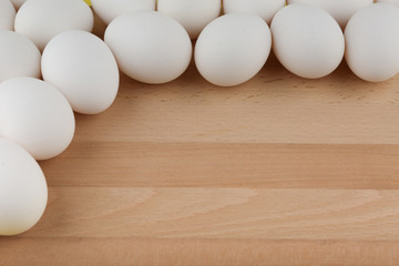 background of eggs on cutting board with copy space top view