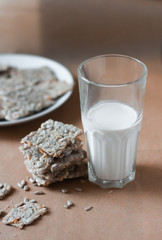 milk and cookies on brown background,  cereal cookies with a glass of milk