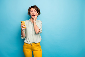 Photo of pretty lady hold telephone open mouth read positive comments followers reaction arm on...