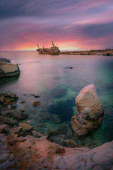 Beautiful long exposure shot of the famous Edro III shipwreck and the cost in Peyia, Paphos region, Cyprus on a sunset