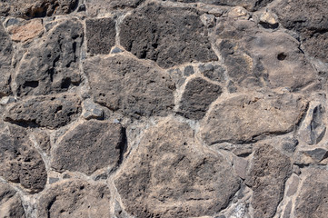 Texture of stone wall made of volcanic rocks