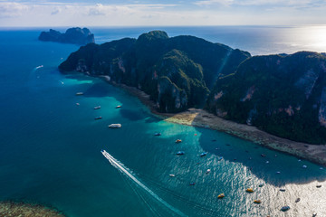 Aerial view of Phi Phi, Maya beach with blue turquoise seawater, mountain hills, and tropical green...