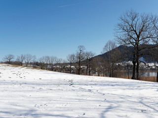 Gmund am Tegernsee in Upper Bavaria. View from Kaltenbrunn to magical calm waters of the lake of Tegernsee in winter