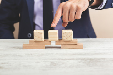 man hand wooden cubes