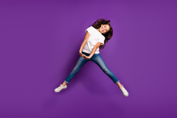 Fototapeta na wymiar Full length body size view of her she nice attractive funky cheerful cheery wavy-haired girl jumping having fun fooling isolated on bright vivid shine vibrant purple violet lilac color background