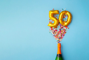 50th anniversary champagne bottle balloon pop - obrazy, fototapety, plakaty