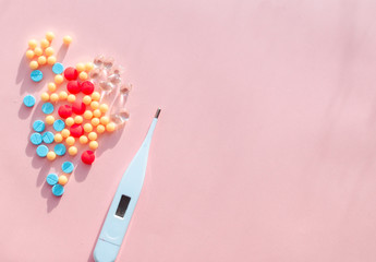 pharmaceutical pills thermometer a pink background. Copy space. the concept of health. concept  of life. assorted medicines. bright pills. coronavirus