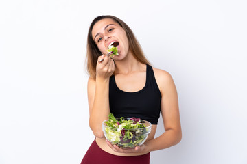 Teenager girl with salad over isolated background