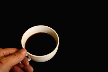 Black coffee in white cup isolated on black background