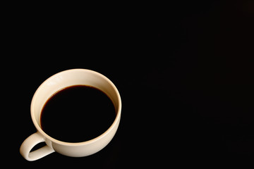 Black coffee in white cup isolated on black background