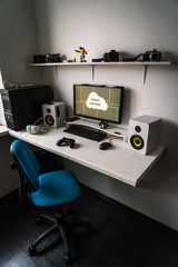 Cloud gaming: the workplace of a professional gamer with a monitor, gamepad, headphones and an armchair.