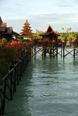 Obraz premium houses on the water against the turquoise sea and cloudy sky