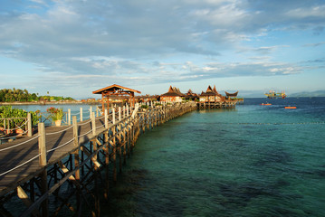 Obraz premium houses on the water against the turquoise sea and cloudy sky