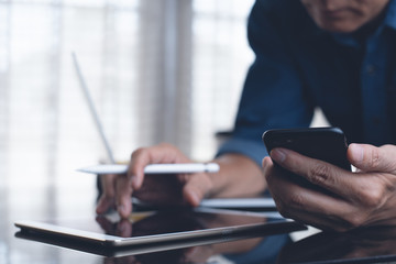 Obraz premium Working on laptop computer, mobile smart phone and digital tablet