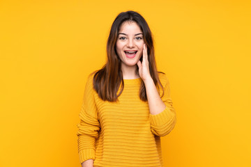 Young caucasian woman isolated on yellow background with surprise and shocked facial expression