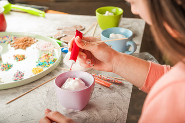 The process of coloring ginger Easter gingerbread cookies close-up. Mixing aisings for gingerbread...