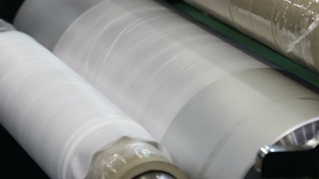 roll of cellophane from the conveyor in production of PVC polymers