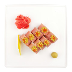 Set of sushi for a large company, rolls, california, philadelphia with lava sauce, ginger and wasabi, white isolated background, view from above