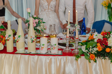Beautiful decoration of the wedding table with flowers and candles.