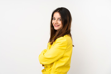 Young caucasian woman isolated on white background with arms crossed and happy